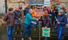 Councillor Jack Welch on steps of Perth and Kinross HQ accepting petition from group of people with save our libraries placards