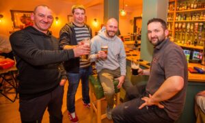 Locals raise a toast at the recently re-opened Tayview Bar in Newburgh. Image: Steve MacDougall/DC Thomson