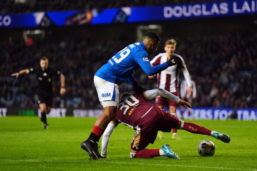 Hamza Igamane and Barry Douglas battle for the ball during St Johnstone's game against Rangers. 