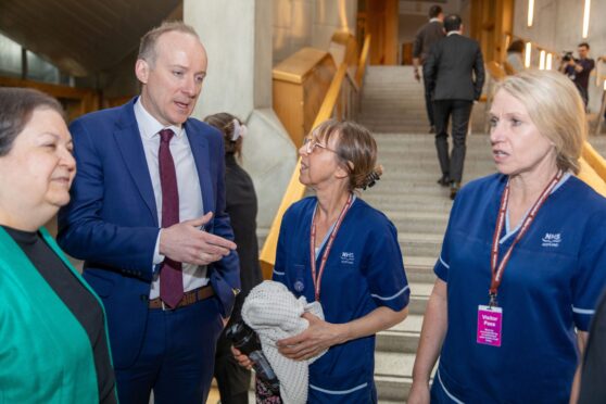 Angus nurses Cathy Fuggaccia and Shona Middleton speak to Labour MSPs Jackie Baillie and Michael Marra in parliament. Image: Steve Brown/DC Thomson