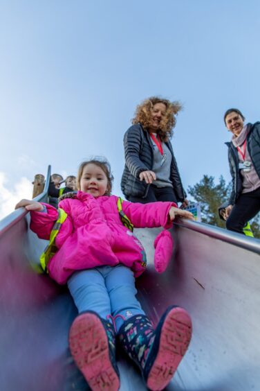 Little girl sliding down chute at Methven play park