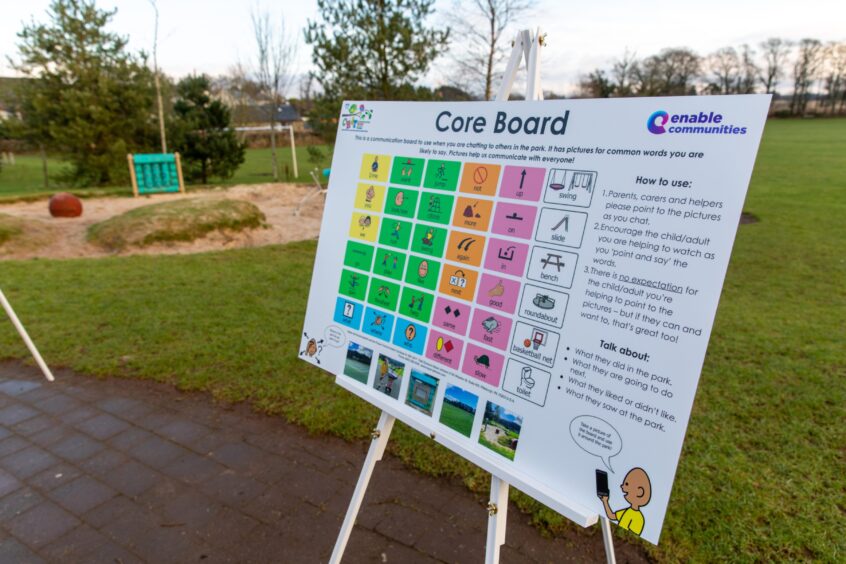 Board next to play park, showing range of symbols and instructions on how to use