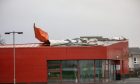 Metal sheets hanging off the roof of the Dunfermline building during Storm Eowyn