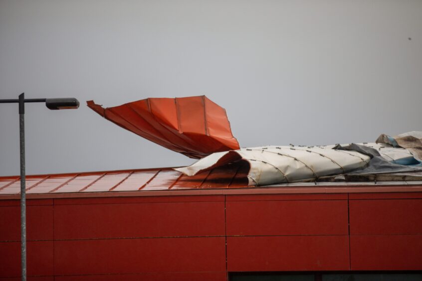 a close-up view of the torn metal sheeting