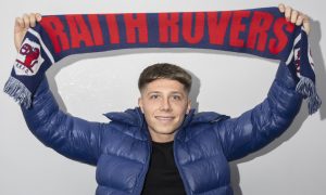 Aiden Marsh holds a Raith Rovers scarf above his head.