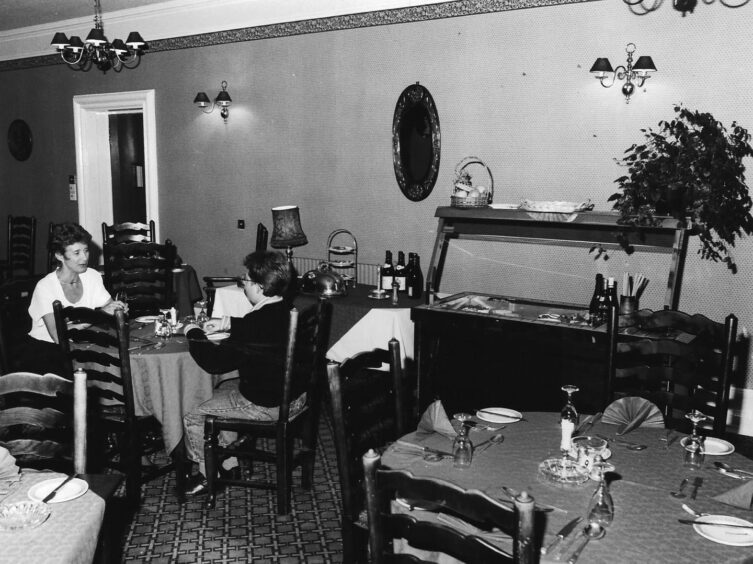 two people sit down to eat in the hotel dining room 