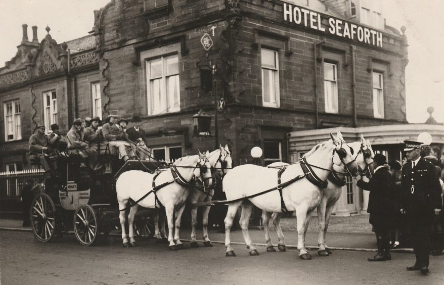 a horse and carriage outside Hotel Seaforth