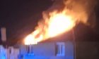 Flames were shooting from the roof of a block on Letham Terrace in Leven. Image: Supplied