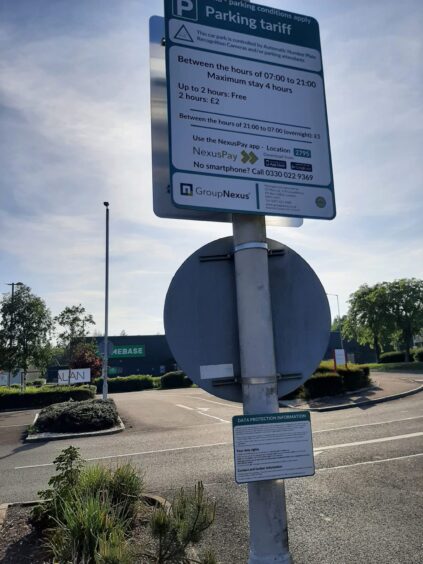 Private Parking signs at the Saltire Centre in Glenrothes, attached to a lamp-post