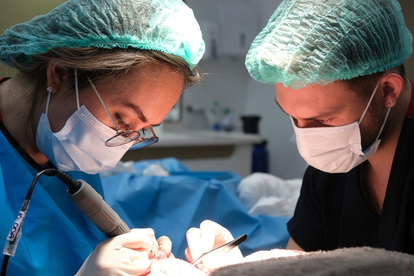 Two clinicians working on a scalp.