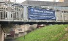 A banner advertising the Wellgate Centre ANPR parking charges on Kirk Lane., Dundee.