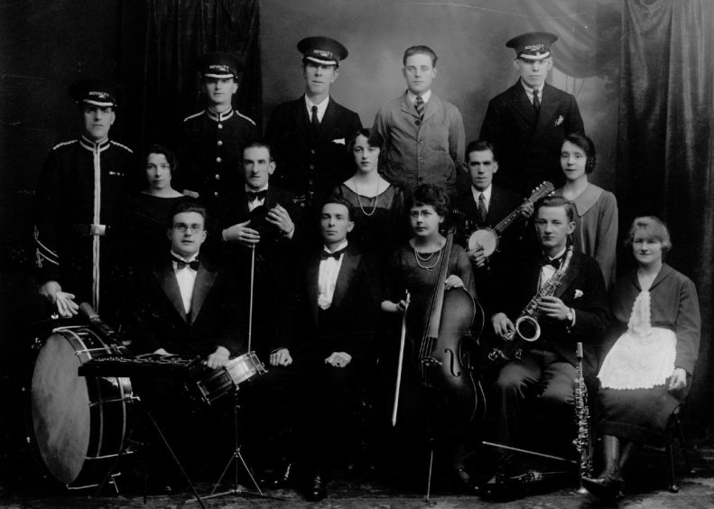 Staff and orchestra, some with instruments, from the Royalty Kinema in 1926. 