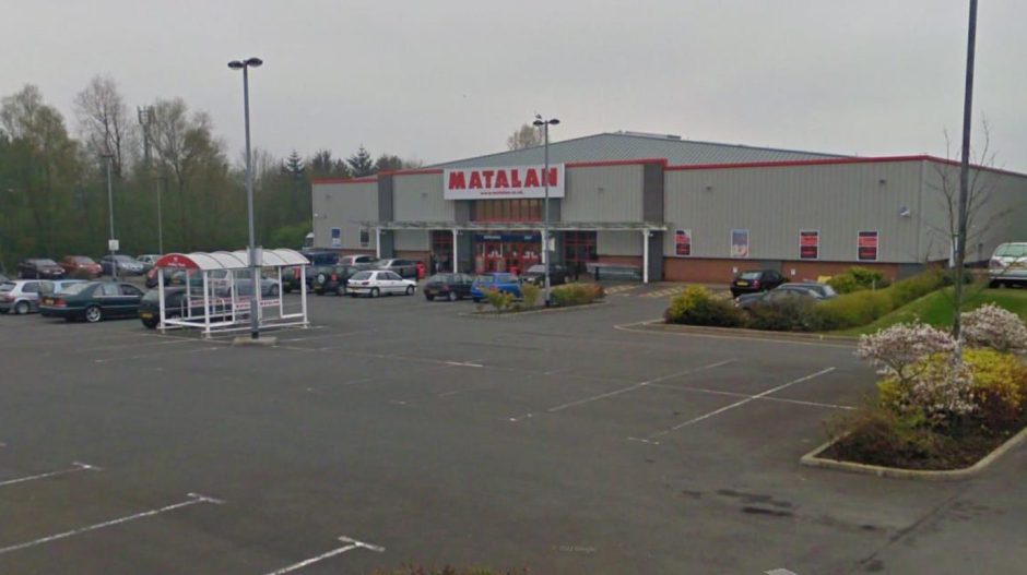 Matalan in Glenrothes, where small signs outlining parking rules and charge are attached to lamp-posts