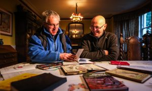 Sophie's father Peter Gackowski, left, and designer Roland Proctor look through the late writer's old notebooks. Image: Mhairi Edwards/DC Thomson.