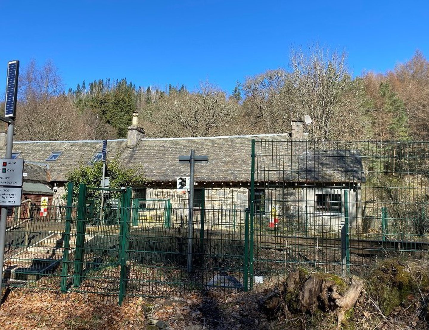 A front view of the cottage behind the railway.