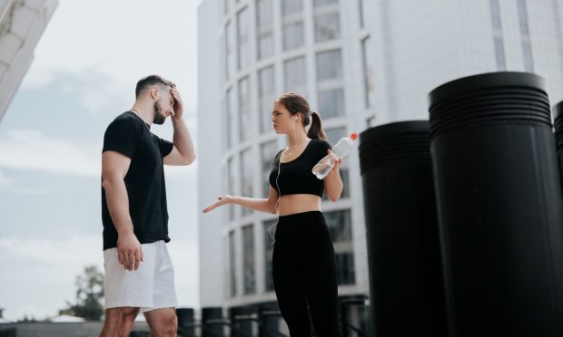 two people in gym gear arguing