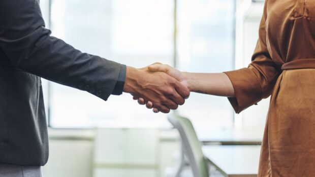 A man and woman shaking hands.