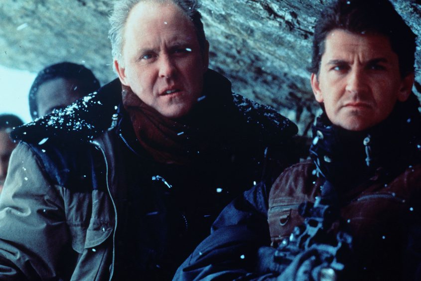 John Lithgow and Craig Fairbrass on a mountainside in a scene from Cliffhanger. 