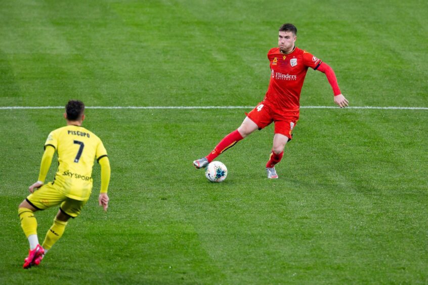 Ryan Strain, right, in action during his trophy-laden stint with Adelaide United