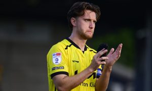 Elliot Watt applauds the Burton Albion supporters.