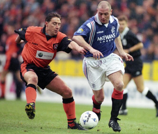 Paul Gascoigne goes up against Dundee United's Jim McInally during his time at Rangers