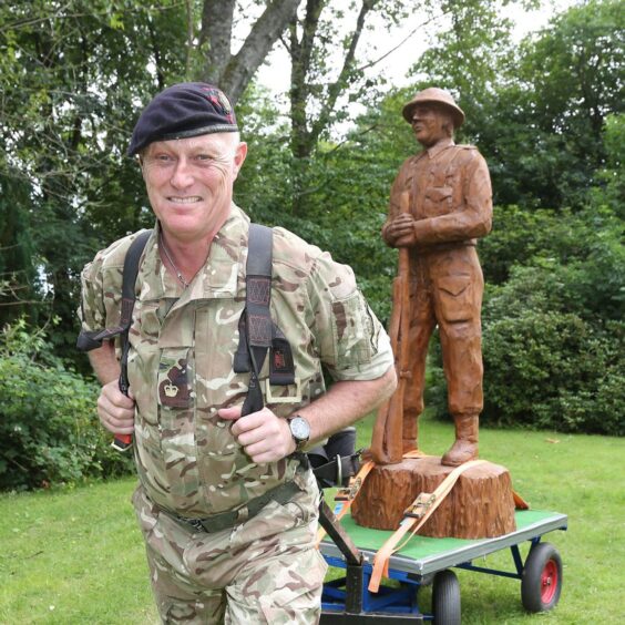 Robin Hood towing cart with life-sized wooden carved soldier