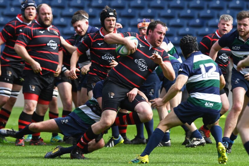 Aberdeenshire's Jason Burton runs at Toby Hughes during the National Bowl Final at Murrayfield in April 2019.