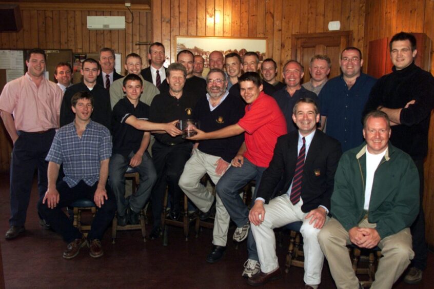 Dundee Junior Rugby Club makes a presentation to Sandy Hutchison in July 2002