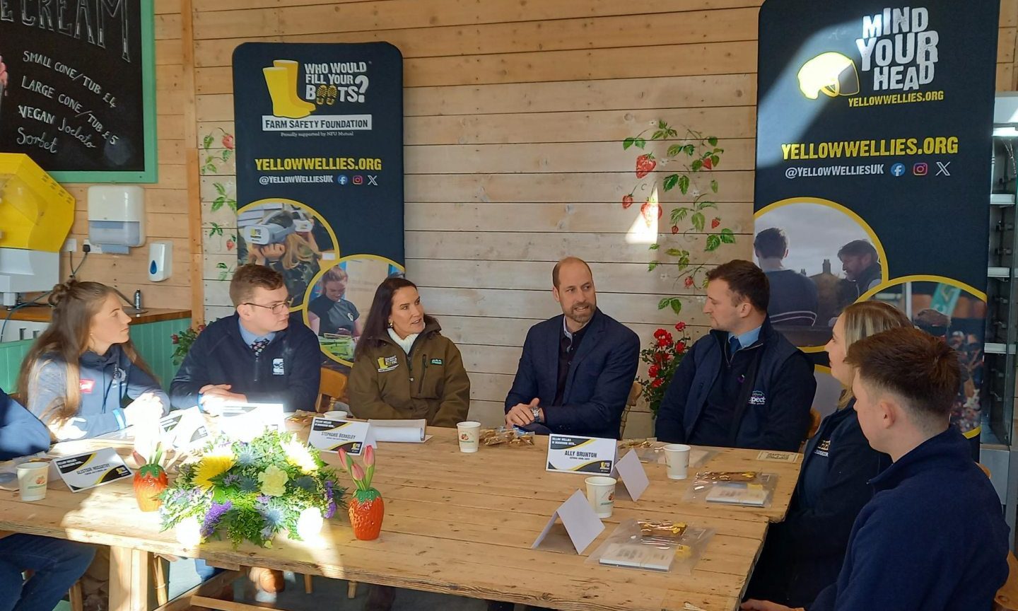 Prince William at East Scryne Farm, Carnoustie, with Stephanie Berkeley of the Farm Safety Foundation to his left and and Ally Brunton of the Scottish Association of Young Farmers Clubs to his right. Image: Graham Brown