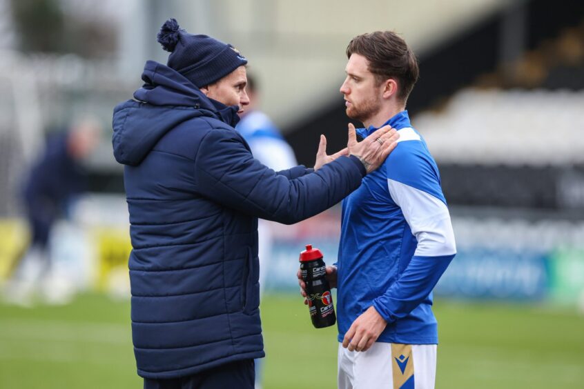 Simo Valakari gets a message across to Elliot Watt in the warm-up. 