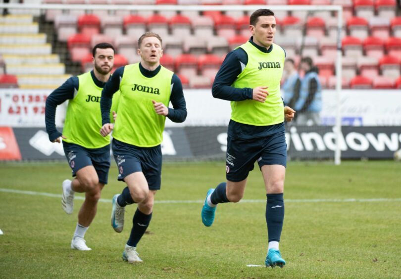 Jordan Doherty, Liam Dick and Paul Hanlon warm up before Raith Rovers' derby against Dunfermline.