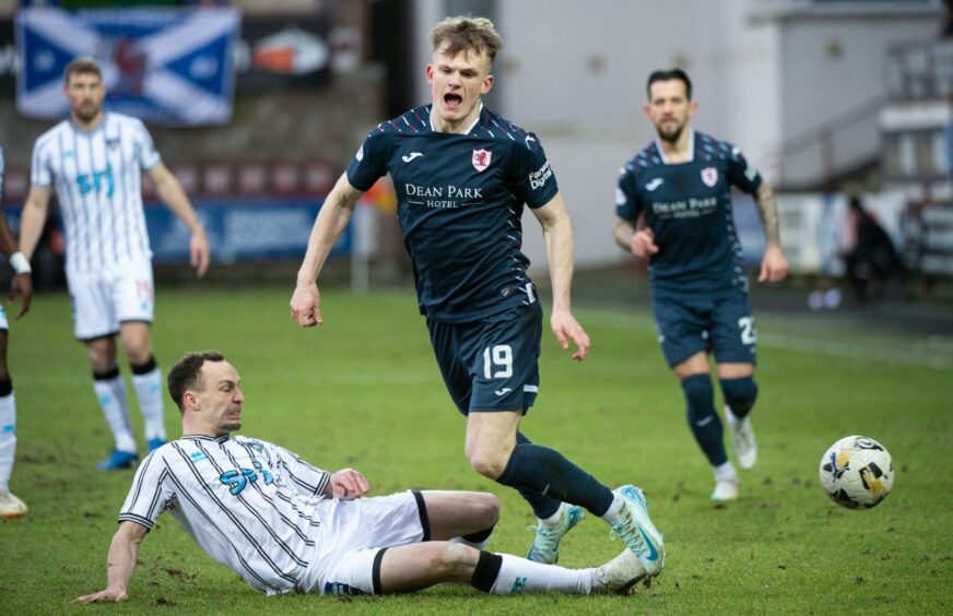 Dunfermline's Chris Hamilton slides in to tackle Raith Rovers winger Finlay Pollock.