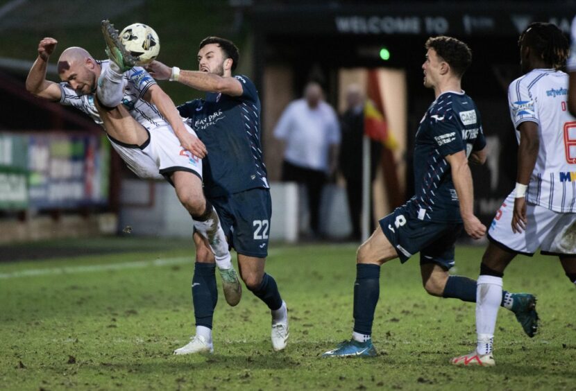 Dunfermline striker Chris Kane battles for possession under a challenge from Raith Rovers' Jordan Docherty.