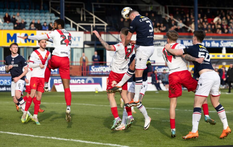 Clark Robertson heads in Dundee's opening goal. Image: Mark Scates/SNS