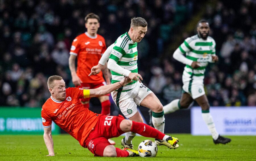 Raith Rovers captain Scott Brown slides in to tackle Celtic counterpart Callum McGregor.