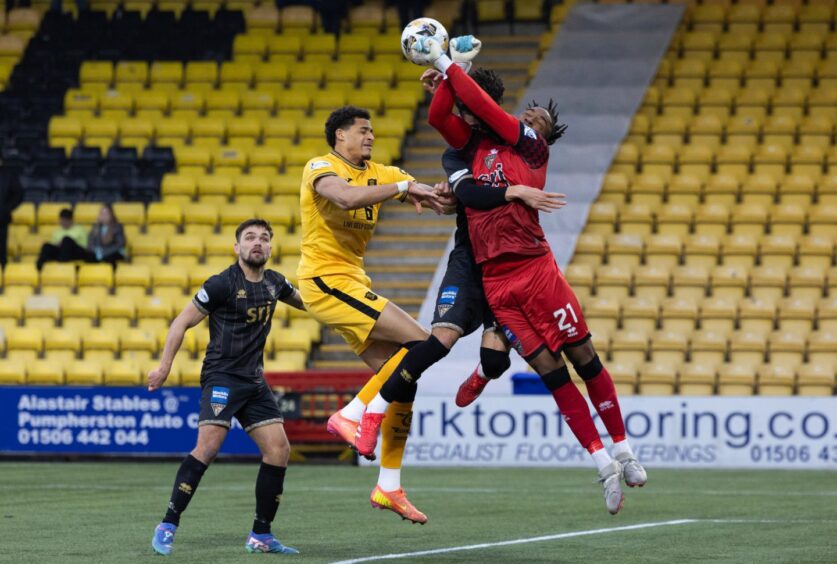 Tobi Oluwayemi punches a ball clear under pressure during Dunfermline's goalless draw with Livingston.