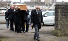 The coffin is carried into the church at the funeral of the late Jimmy Calderwood.