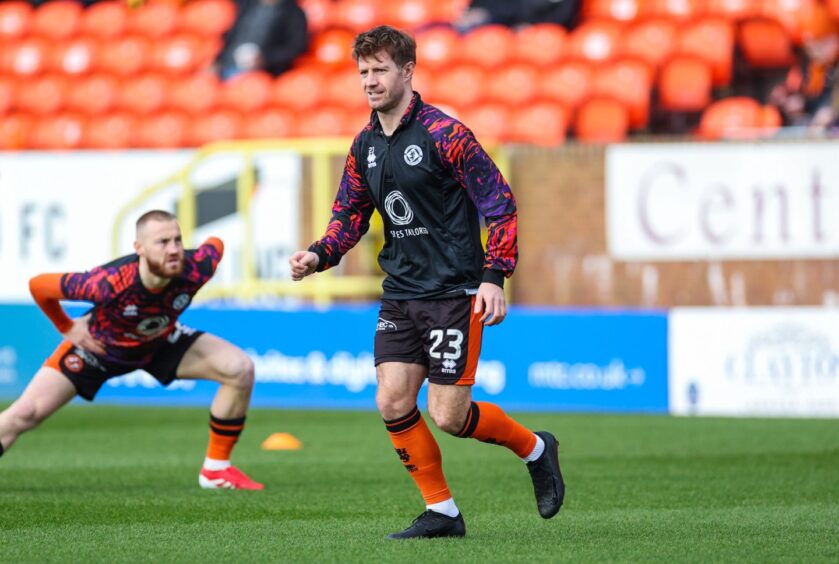 Ross Docherty, right, warming up prior to kick-off.