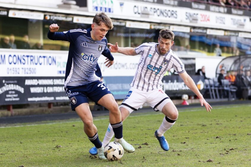 David Wotherspoon challenges Queen's Park's Adam Montgomery for the ball.