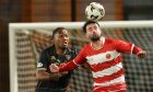 Dunfermline defender Kieran Ngwenya challenges Hamilton Accies opponent Reghan Tumilty for a header.