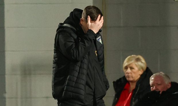 Dunfermline boss Michael Tidser holds his head in his hands.