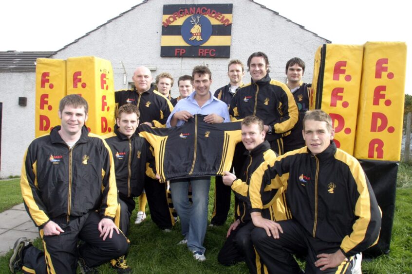 Players and officials pose for a pic as Morgan Rugby Club is presented with 25 sets of kit and two post protectors by Fife company FFDR