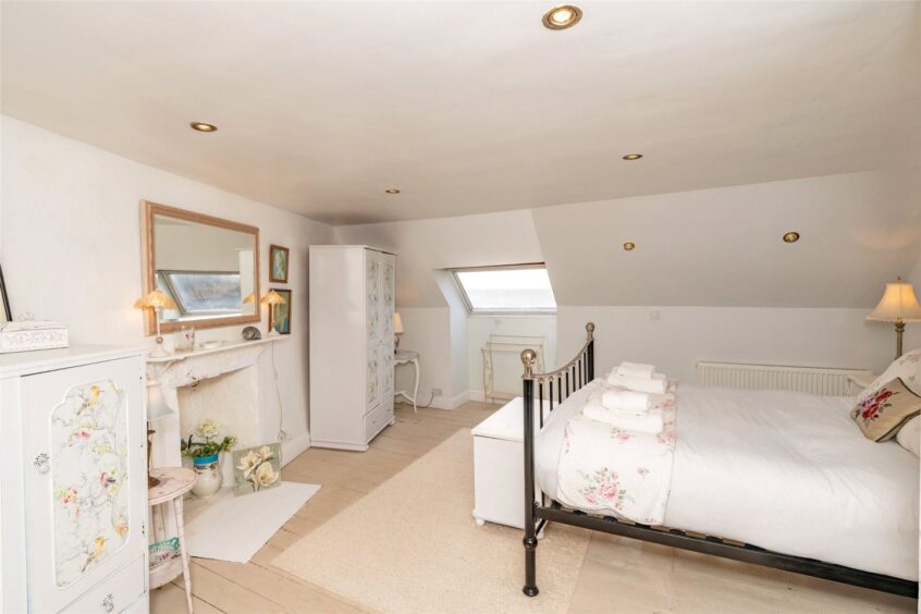 The master bedroom features a coombed ceiling.