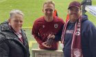 Mary Getty and grandson Allan presenting Arbroath FC player Scott Stewart with an award at a previous game. Image: Allan Getty