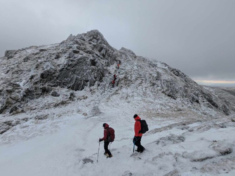 A flash of colour as walkers ascend craggy Ben Venue.