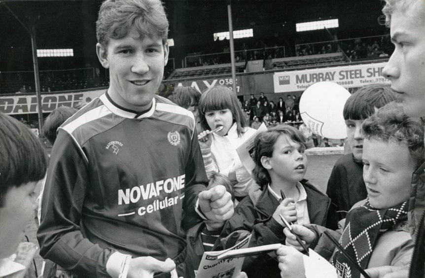 Striker Keith Wright signs autographs for young Dundee FC fans in 1988.