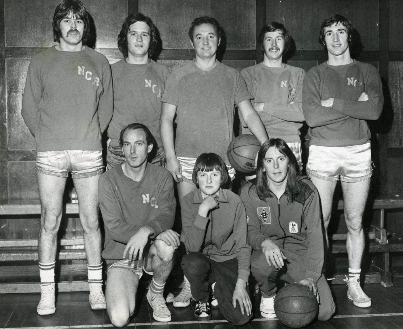 The NCR men's basketball team pose for a picture in December 1973