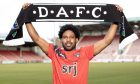 St Johnstone defender Andre Raymond holds up a DAFC scarf.