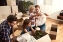 parents with children, playing and bonding together as they are moving house in UK