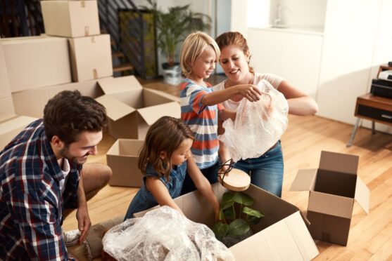 parents with children, playing and bonding together as they are moving house in UK